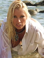 Wet and wild fun as Lana drapes over the beach rocks