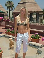 Kelly stands outside and strips down to her bra!