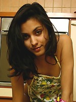 Girl gets naked and plays with her pussy in the kitchen