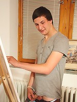 The redhead opens her robe and poses for the two guys painting her naked body