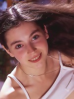 A gleefully shy young woman peels away her clothing..