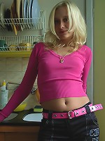 Blonde haired beauty does a strip tease in her apartment..