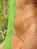 Sexy teen is naked under fishnet