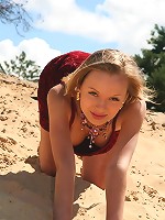 Petite blonde teen gets naked at the beach