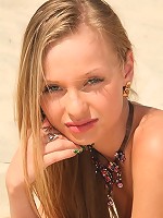 Petite blonde teen gets naked at the beach