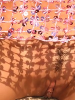 Cute brunette teen strips at the beach