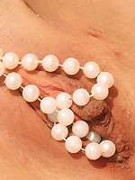 Horny teen puts pearls in her pussy