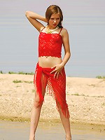 Small breasted Eva getting naked on the beach