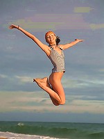 Very skinny and sporty teen jumping and flying naked on the beach