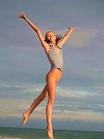 Very skinny and sporty teen jumping and flying naked on the beach