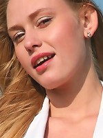 Busty blonde takes off her jacket and panties on the beach