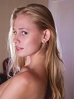 Blonde babe with big natiral breasts posing naked with the fan