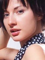 Curly brunette teen takes off her sheer clothes