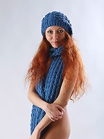 Beautiful curly redhead Kesy posing in blue hat and scarf