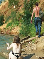 Pale natural blonde babe posing naked on the river