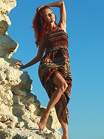 Petite young redhead girl getting nude on the beach