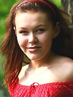 Tattooed chick removes her red dress by the river