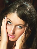 Alluring brunette in sexy black lingerie, stiletto shoes and sheer stockings.