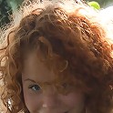Red-haired nymph masturbating outdoors