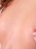 Naughty girl on bed poses seductively