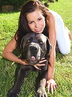 Naughty teen Kiki posing with huge dog outdoors