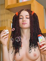 Nude dreadlock teen plays with soap bubbles